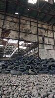 Bunch of tires from wheels. Pile of used tires lays at an old dump Vertical video