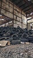 Old tires at a dump. Pile of old tires stacked in junkyard panned up from base to top Vertical video