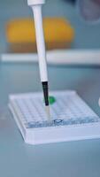 Scientist working at the laboratory. Close up of scientists research in laboratory process Vertical video