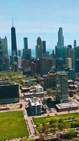 Green quarters with blocks of flats and numerous parking lots. Usual architecture at the backdrop of fantastic skyscrapers. Vertical video