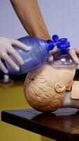 Medical simulation mannequin used for practicing techniques with oxygen mask. Healthcare and education. Vertical video