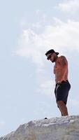 Man resting after training. Young man enjoying the nature during rest after training Vertical video