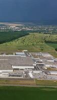 Aerial view place of industrial buildings. Aerial view of the industrial zone of the new modern industrial buildings Vertical video