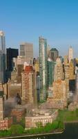 Manhattan island beautiful architecture. Fog coming to the city from blue waters of the river. Aerial perspective. Vertical video