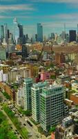 Sunny New York quarters with diverse architecture. Aerial view of metropolis with skyscrapers at backdrop. Vertical video