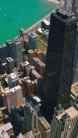 Turquoise waters of scenic Michigan Lake. Glorious skyscrapers built up on the bank of the lake. Aerial view. Vertical video