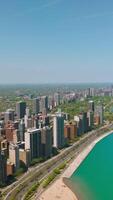 Luxurious and expensive skyscrapers facing Lake Michigan. Chicago city, Illinois panorama on beautiful sunny day. Vertical video