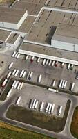 Top view of a large industrial center with parking for trucks. Aerial view on the modern manufacturing complex. Vertical video