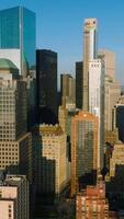 Diverse buildings and skyscrapers of Lower Manhattan Financial District in the sun light. New York city architecture at the backdrop of blue clear sky. Vertical video
