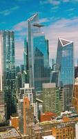 Azure sky reflecting in the mirror windows of skyscrapers. New York city diverse architecture on beautiful sunny day. Vertical video