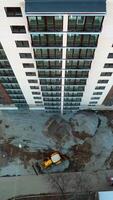 Construction of modern building. Aerial view of high construction building Vertical video