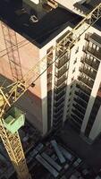 Crane for building. Crane for constructions of large building working on building Vertical video