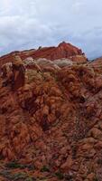 Rising along the outstanding surface of an orange rock. Unbelievable scenery of amazing canyons in Zion National park, Utah, USA. Vertical video