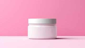 A jar of cream sits on a pink background photo