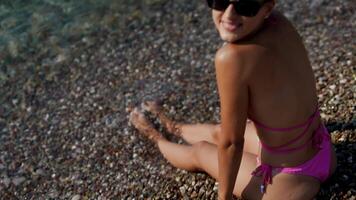 Taking some time to relax by the clear and inviting waters of a beautiful beach paradise video