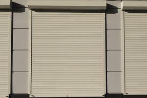 Blinds on the house. Shutters on the window. Plastic blinds on the display case. photo