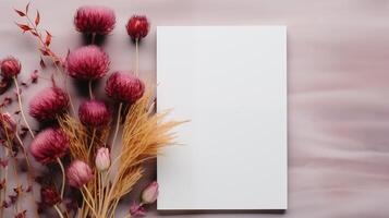 Blank card mockup with pink thistle and dried flowers on soft background. Boho decor. Event invitation, poster template advertising image. Autumn floral flatlay mock up photorealistic photo