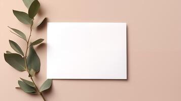 Blank white card mockup with eucalyptus branch on peach background. Elegantly arranged paper template advertising image. Fresh organic feel with soft tones mock up product photorealistic photo