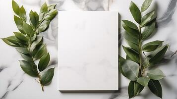 Blank white canvas with symmetrical green leaves arranged on both sides. Foliage against marble surface. Natural template advertising image. Botanical mock up product photorealistic photo