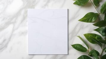 Simple white canvas mockup placed on marble surface with green leaves on right. Botanical template advertising image. Greenery minimalistic composition mock up product photorealistic photo