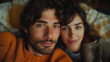 Couple together on cozy bed gazing affectionately at camera portrait image. Relaxed expressions, home comfort picture photorealistic photography. Relationships concept photo realistic