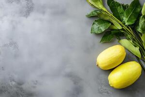 Two ripe yellow lemons with leaves lying on gray textured background etrog and lulav yom kippur photo