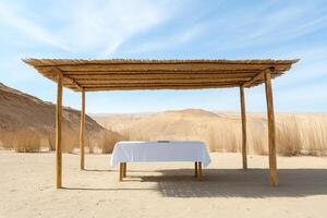 Table with white tablecloth under wooden canopy in the desert sukkah photo