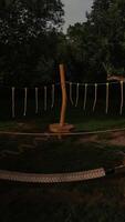 Wooden obstacle on the playground standing on green grass under cloudy sky photo