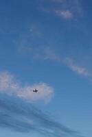 Airplane gliding through a serene evening sky photo