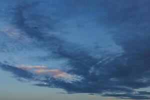 Colorful clouds in the evening sky before dusk photo
