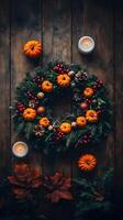 Autumn Wreath with Pumpkins Pine Cones and Cranberries on Rustic Wood photo