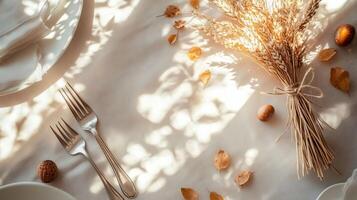 Autumn Table Setting with Wheat Dried Leaves and Forks photo
