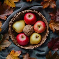 Autumn Harvest Apples Nuts and Fall Leaves in a Basket photo