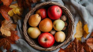 Autumn Fruits in a Wicker Basket with Leaves photo