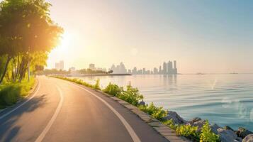 A road leading to the ocean with trees and a city skyline in the background photo