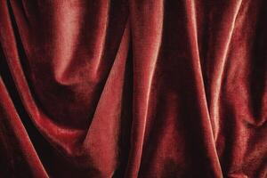 Close-up of Red Velvet Fabric Draped in Soft Folds photo
