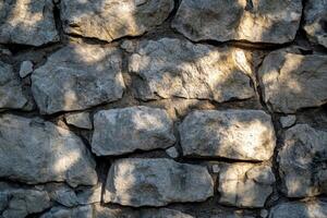 Rough Stone Wall Texture with Light and Shadow Patterns photo