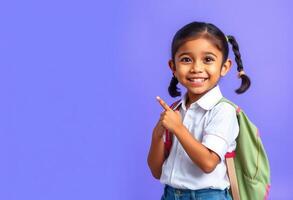 Smiling Schoolgirl with Backpack Pointing to Copy Space photo