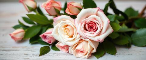 A Delicate Bouquet of Pink and White Roses on Whitewashed Wood photo