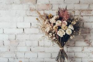 Dried Flower Bouquet Against a White Brick Wall photo