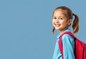 Smiling Schoolgirl with Red Backpack on Blue Background photo