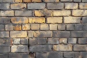 Weathered Brick Wall with Grey and Yellow Tones photo