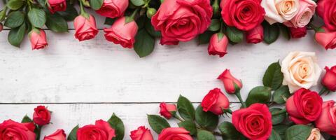 Red and Peach Roses Bordering White Wood photo
