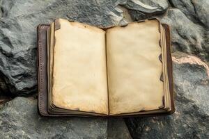 Open Antique Book on Rough Stone Surface photo