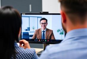 Two People in a Call with a Man on the Screen photo