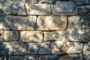 Stone Wall with Shadow Patterns in Sunlight photo