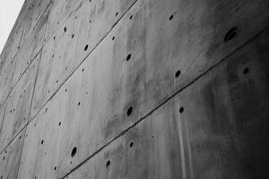 A Gray Concrete Wall with Round Holes photo