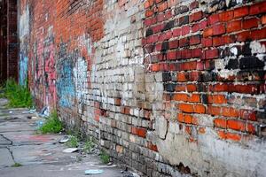 Weathered Brick Wall with Graffiti and Debris photo