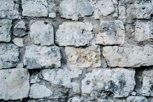 Weathered Stone Wall with Irregularly Shaped Blocks photo