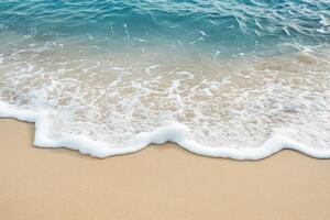 White foamy wave cresting on sandy beach photo
